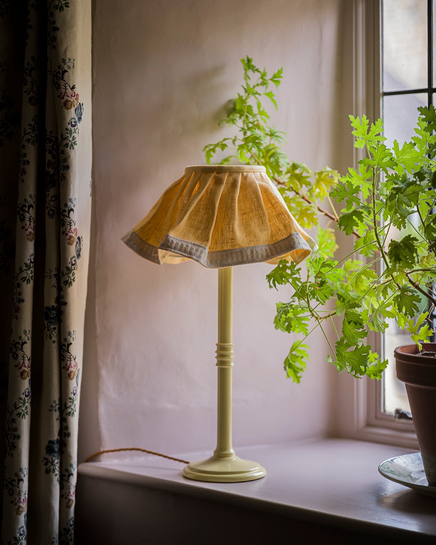 Lacquered lampstand in buttercup used in a home