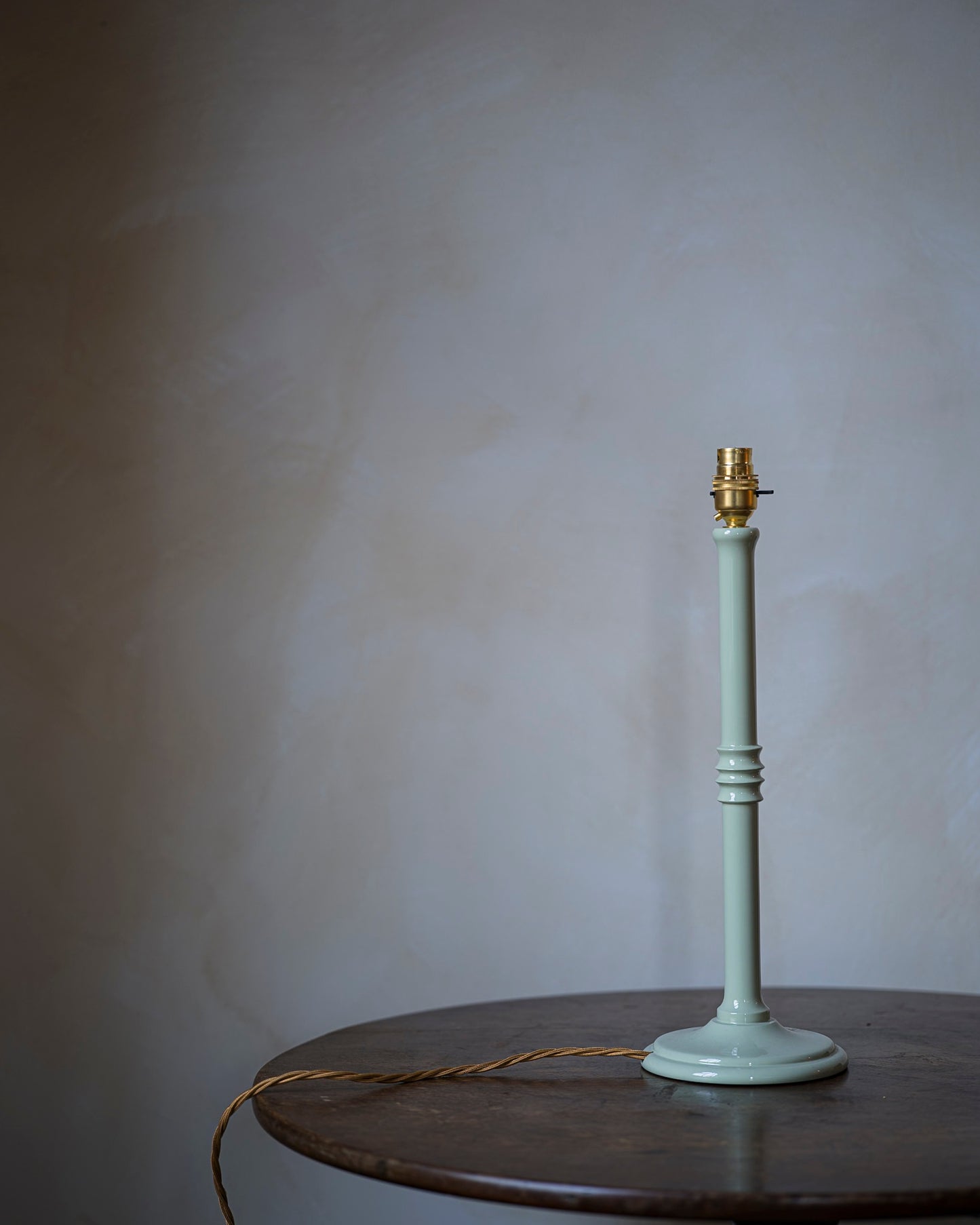 Lacquered lampstand in hellebore on table