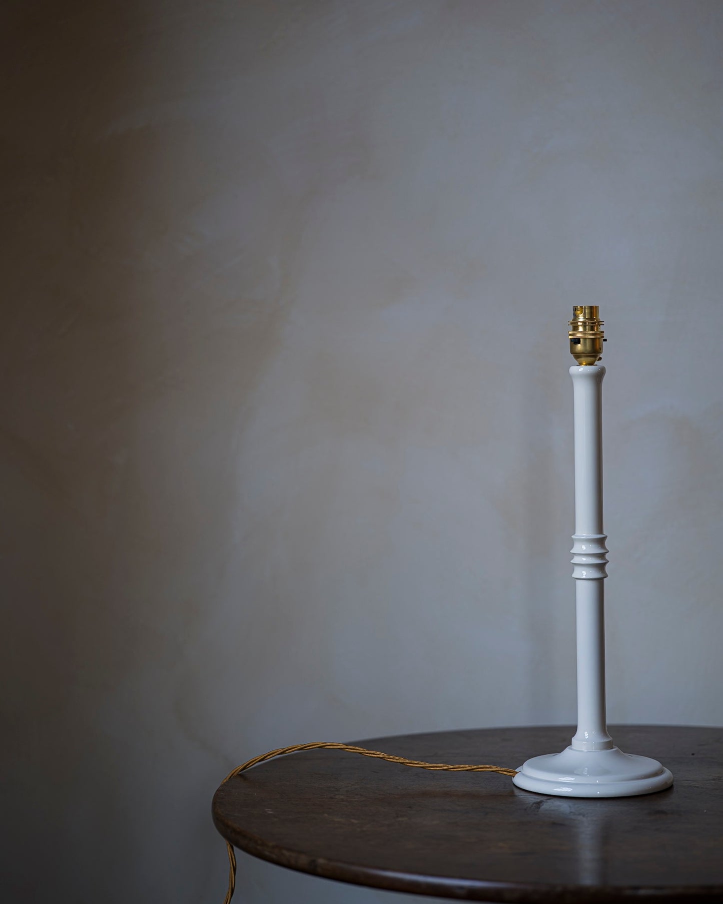 Lacquered lampstand in magnolia on table
