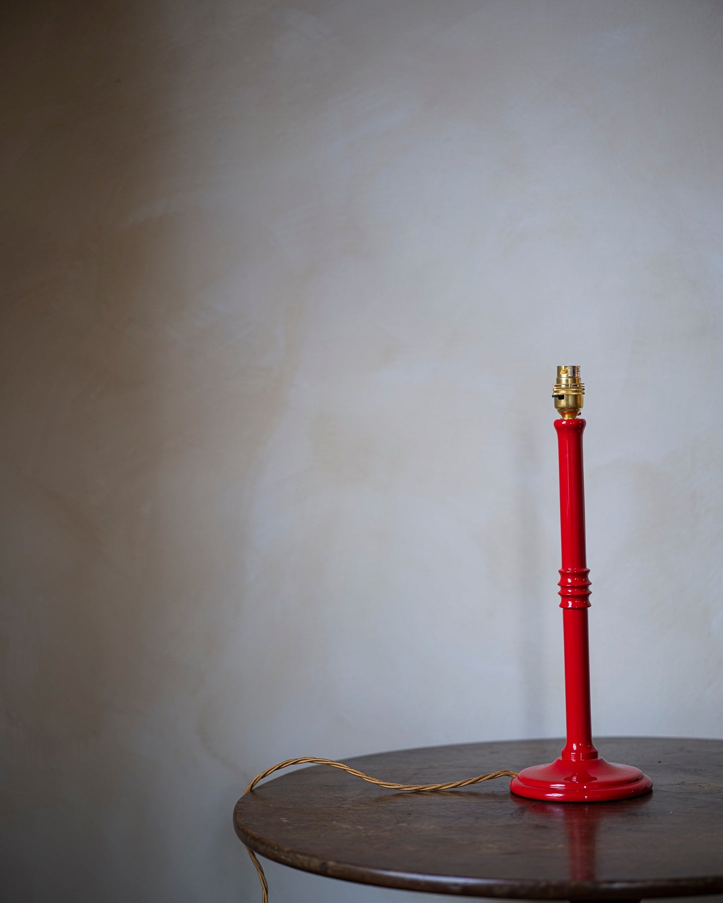 Lacquered lampstand in strawberry on table