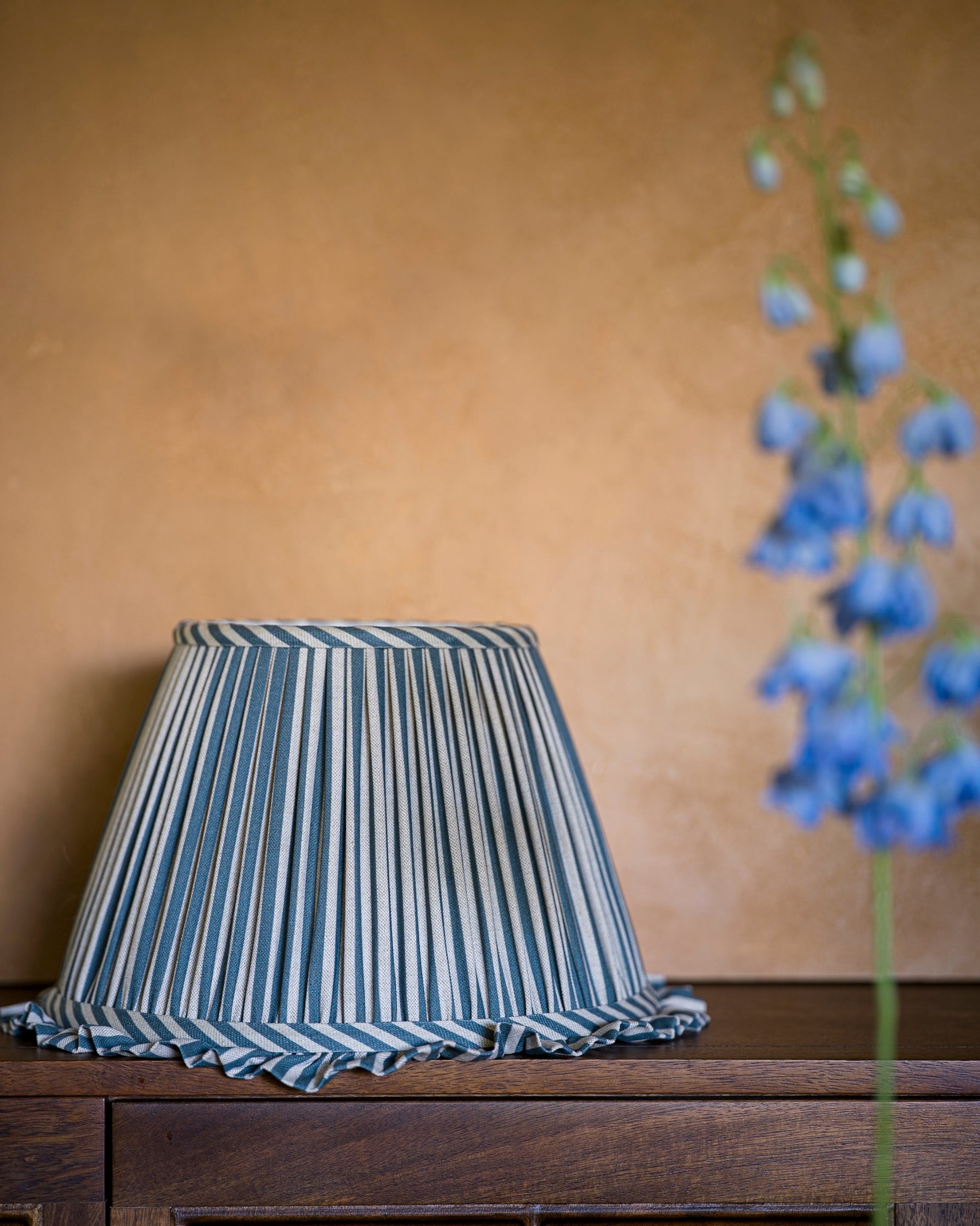 Luxury frilled lampshade in delphinium on drawers