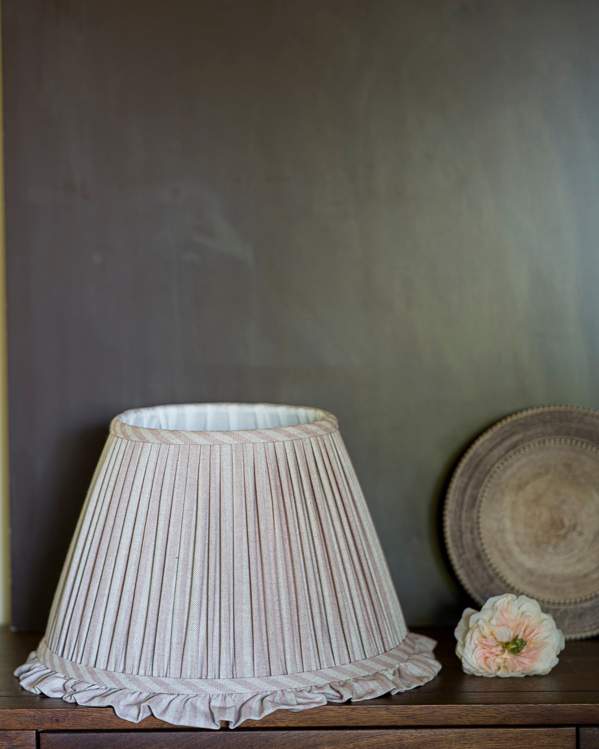Luxury frilled lampshade in old rose on drawers
