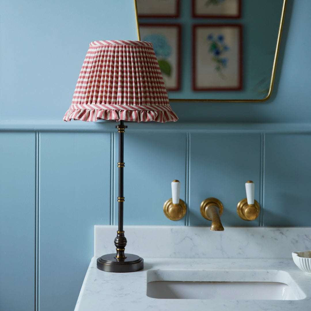 Luxury red lampshade with lampstand on a sink