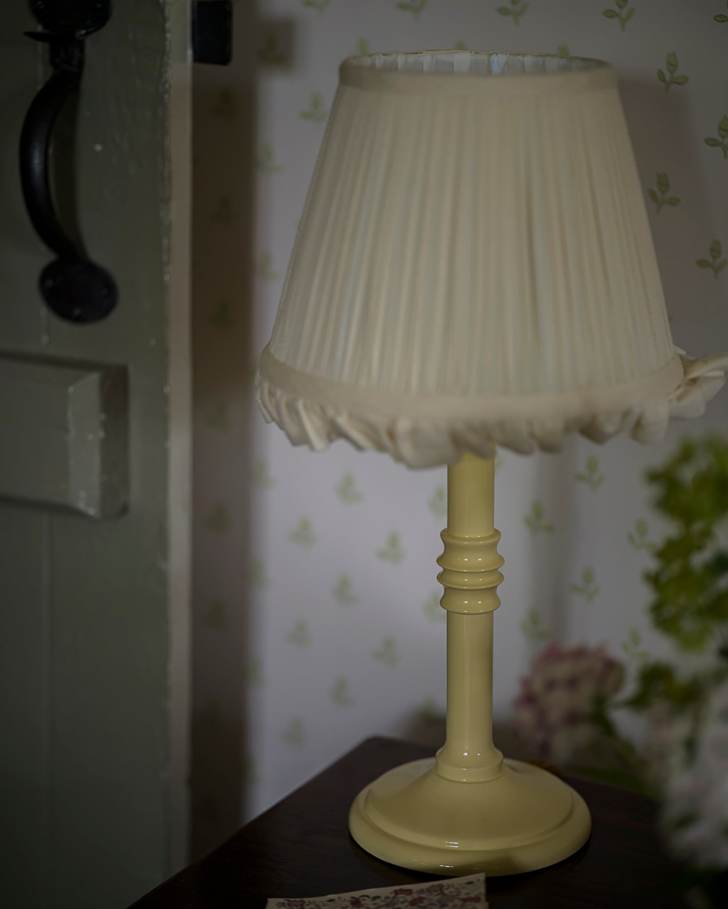 Small lacquered lampstand in buttercup on set of draws zoomed in