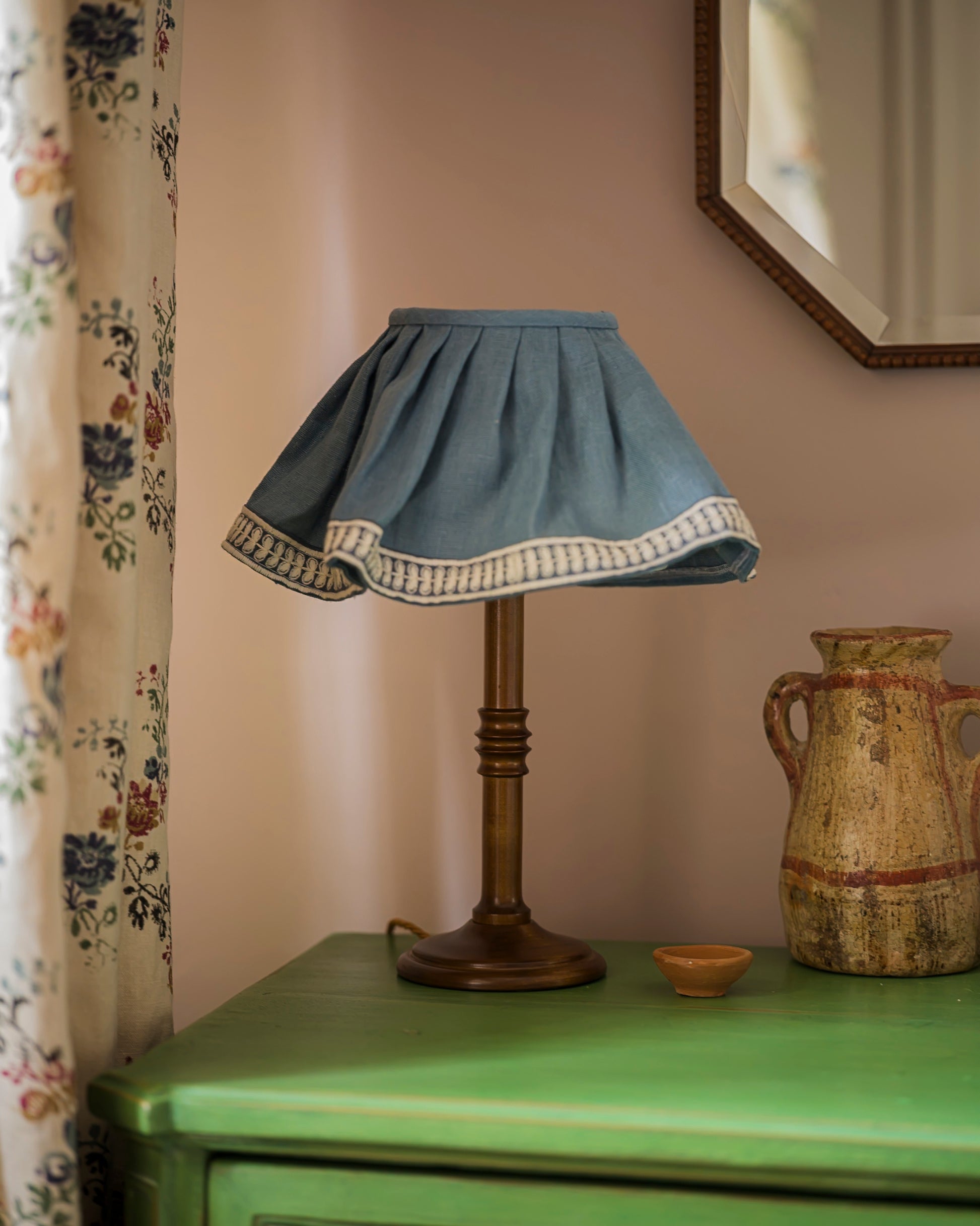 Small unlacquered lampstand in wood on green drawers
