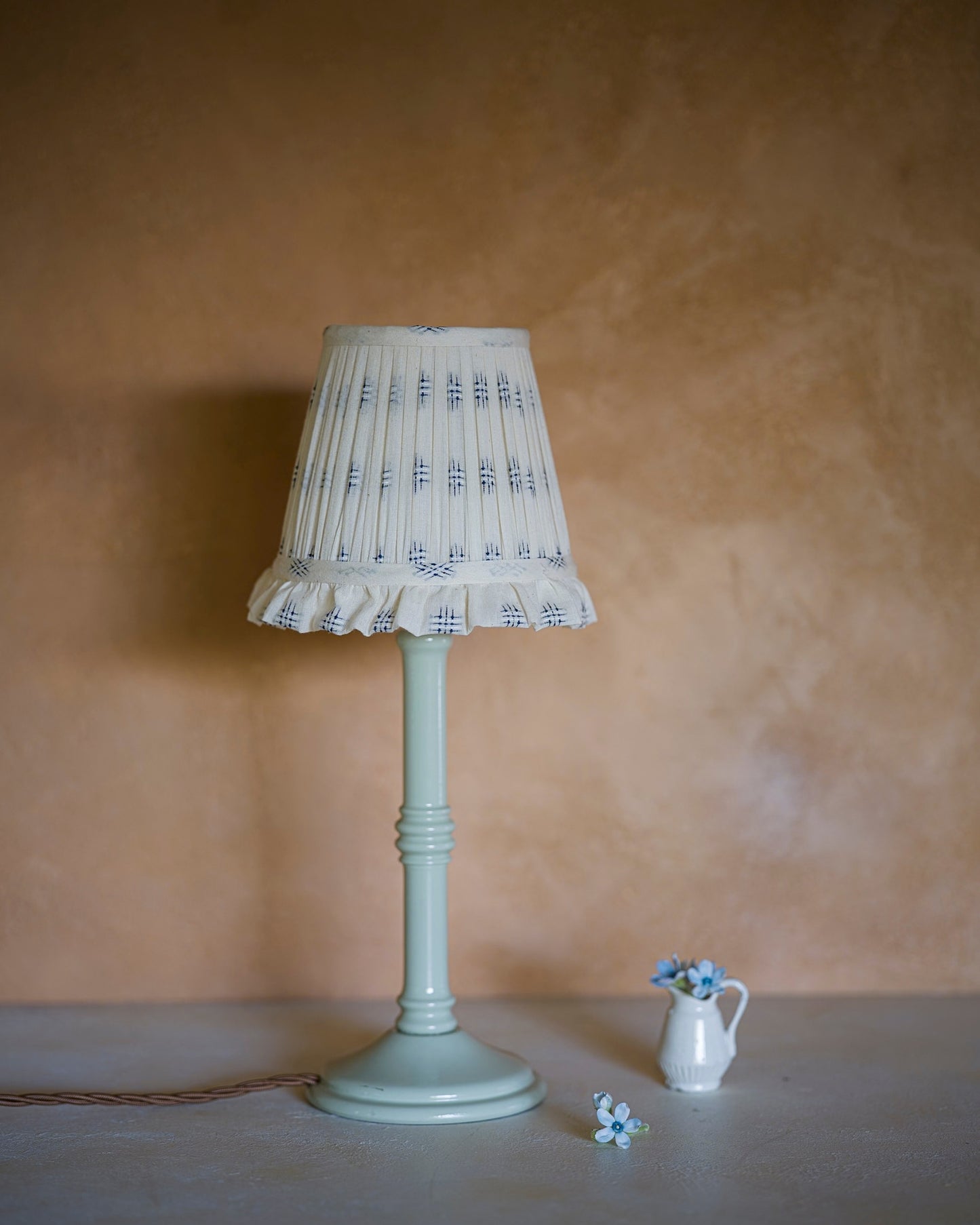 Embroidered wall light lampshade in cornflower on lampstand
