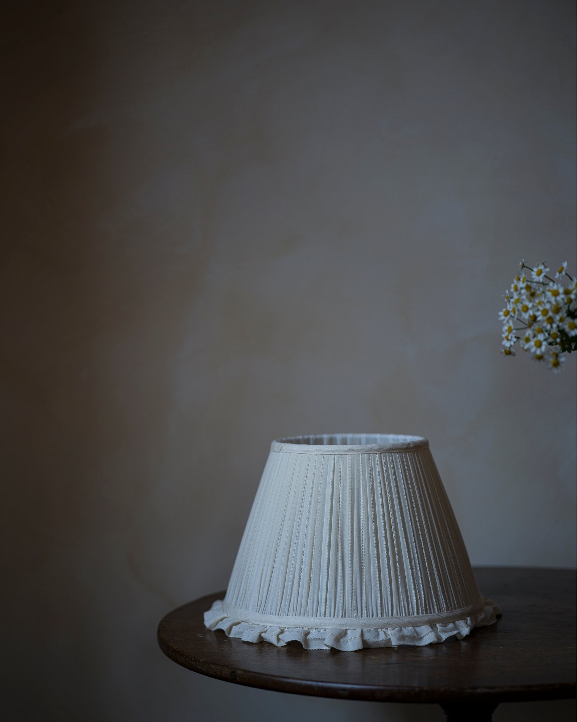 Luxury frilled lampshade in daisy on table