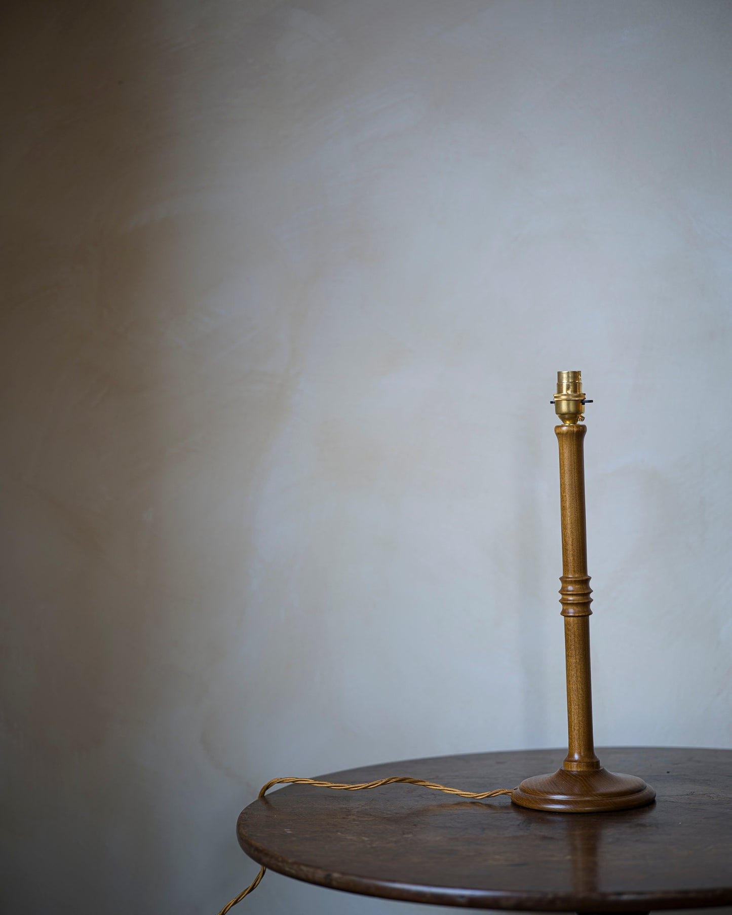 Unlacquered lampstand in wood on table